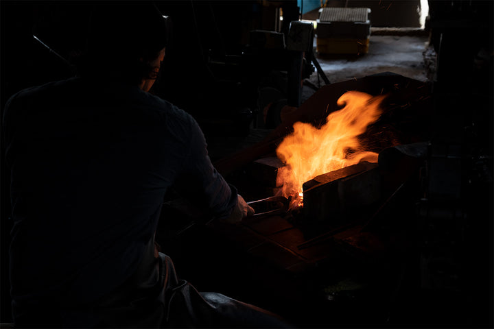 a lit forging oven and orange flames from a japanese chef knife blacksmith chefs edge australia